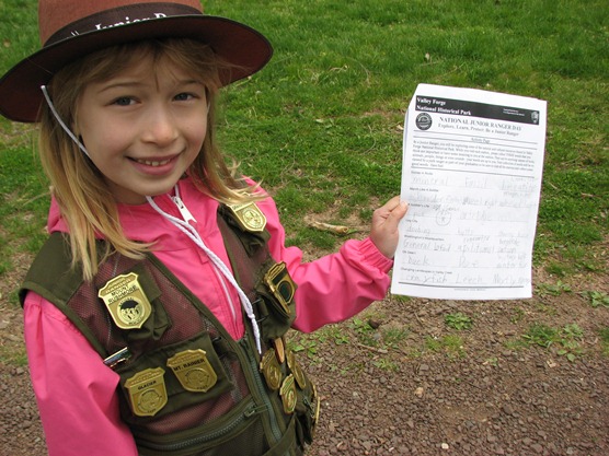 Junior Ranger holding her completed worksheet