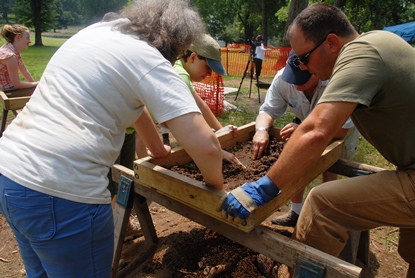 Archeology volunteers screen for artifacts