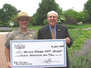 Superintendent Mike Caldwell receives check from Paul Decker.