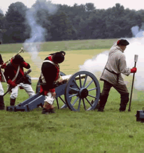 Three Continental soldiers firing off cannon.