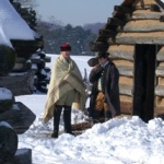 Soldiers in front of a hut in winter