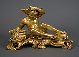 A gilt-bronze inkstand in the form of a river god. The male figure reclining on waves and holding a seashell above his head.