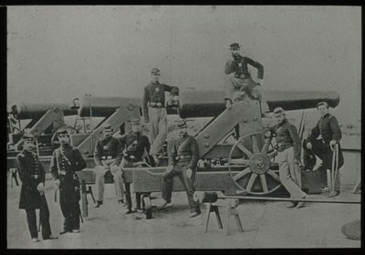 Union soldiers pose in front of a cannon