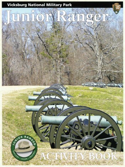 The cover of the Vicksburg Junior Ranger Booklet featuring a picture of leafless trees and green oxidized civil war cannons.