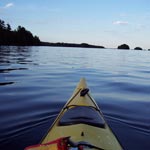 looking towards a watery horizon line from the seat of a kayak