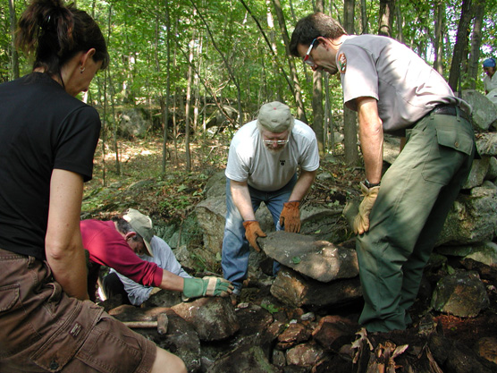 Horticulturist Greg Waters supervises stone wall reconstruction during National Public Lands Day.