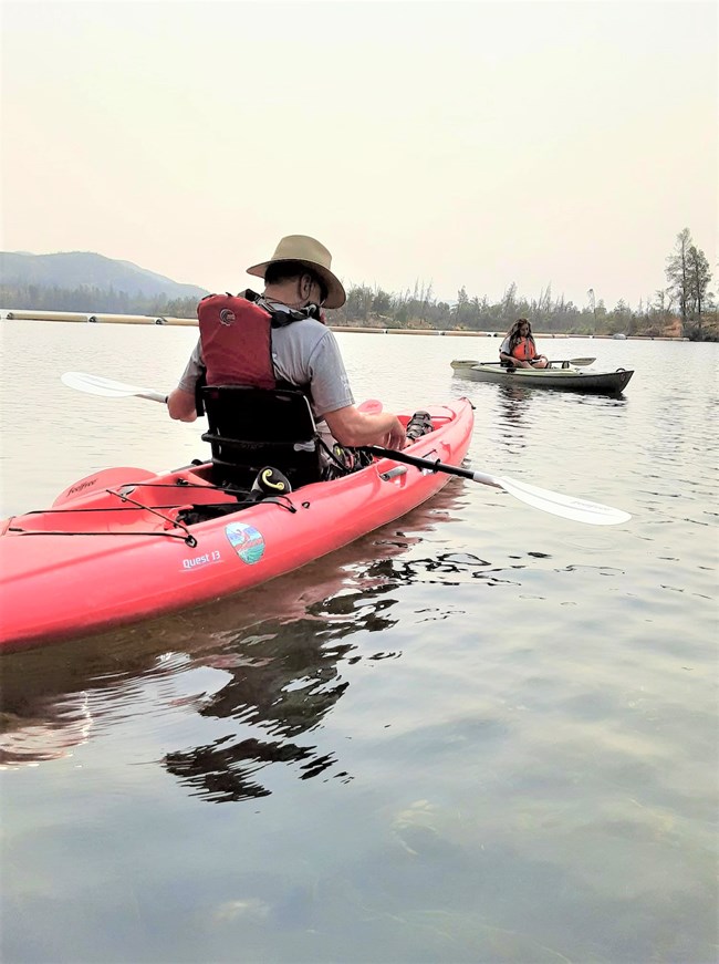 A park ranger and visitor on kayak on Whiskeytown Lake during a ranger-led kayak tour. Kayaks for these public programs have been purchased over the years by Friends of Whiskeytown.