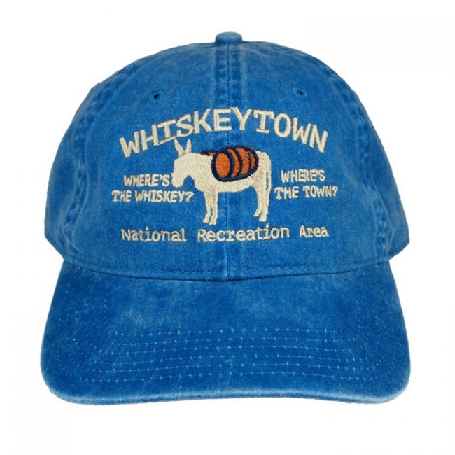 Western National Parks Association sales item. Blue baseball cap stating "Where's the Whiskey? Where's the Town? Whiskeytown National Recreation Area." Picture of mule.