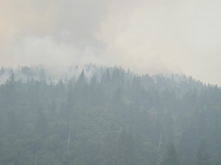 Smoky conditions hamper firefighting efforts.