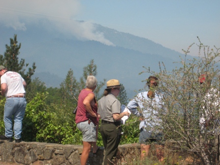 Park Ranger speaks to visitors about fires burning on Shasta Bally seen in background.