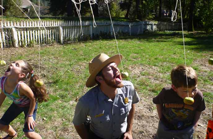 visitors playing apple game with park ranger