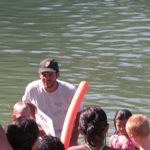 Image of a ranger speaking with visitors about water safety at Brandy Creek Beach
