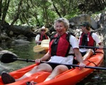 Image of a visitor enjoying a kayak tour on the cool waters of Whiskeytown Lake