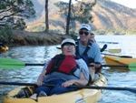 Image of a visitor on the Special Access Kayak Program experiencing Whiskeytown Lake with a volunteer "kayak buddy"