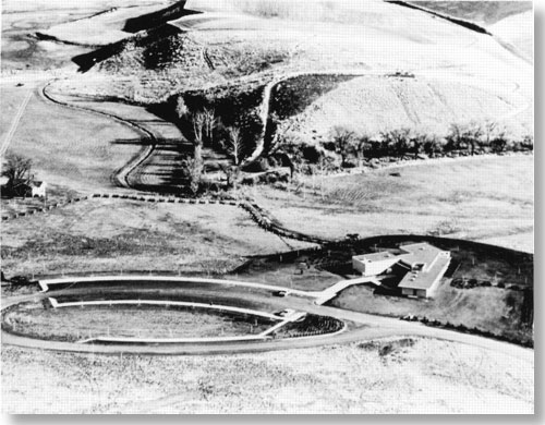 Ariel view of Visitor Center along with sidewalks and circular road for parking.