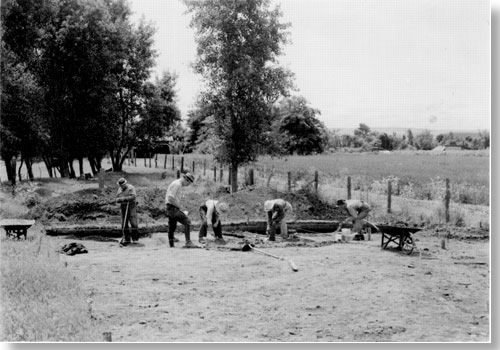 Historic photo of five men working at archeology dig.