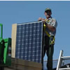 park ranger standing next to solar panel