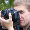 photographer looks through lens of camera