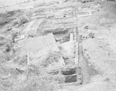 Photo showing a newer foundation resting on top of an older adobe foundation.