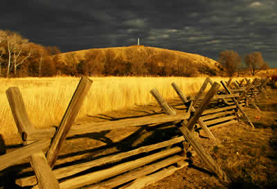 evening light creates a golden foreground and a sky filled with dark clouds