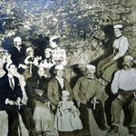 Early cave tour in Wind Cave.  William Jenning Bryant in center of picture with a child.  Tour guide Kate Stabler on the far right.