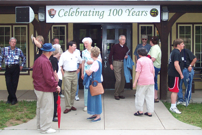 Crowd of people standing in front of the park visitor center in 2003 during the last employee reunion held by the park.