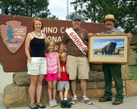 The Bree family from Wisconsin, Jeannette, Mallory, Aidan, and Joe, were presented a framed bison print by Acting Superintendent Steve Schrempp for being the cave’s sixth-millionth visitors.