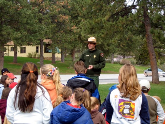 A park ranger conducting an environmental education program at Wind Cave National Park for area school children.