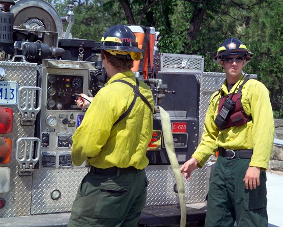 Wind Cave firefighters Mike Mattmiller and Matt Koller ready equipment in case fire breaks out in or near the park.