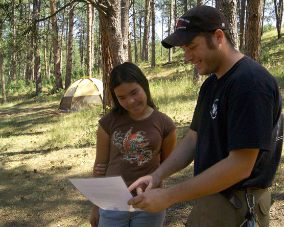 Forestry Technician Rob Schultz explains Wind Cave National Park’s fire restrictions to Vanessa Mendoza from Chino, California