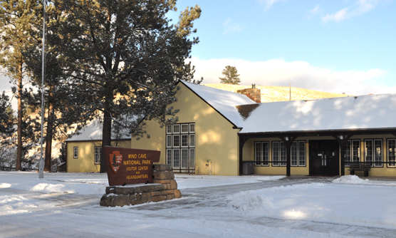 The Wind Cave National Park Visitor Center in winter with snow on the ground.