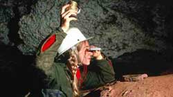 Caver reading a compass.