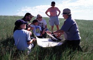 Family with Ranger on a prairie hike.