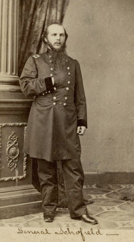 A man in a Union officer's uniform poses for portrait