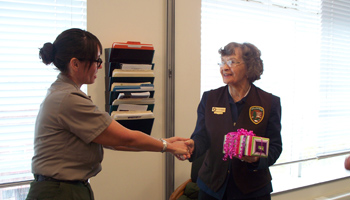Volunteer Helen Kirker is congratulated by Park Superintendent Tammy Duchesne