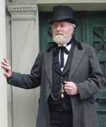 Dick Crozier dressed in 1840s costume and portraying a politician.