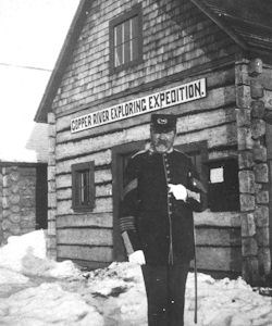 Historic photo of Captain Abercrombie in front of wood Copper River Exploring Expedition building.
