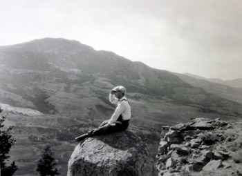Possibly H. E. Stork, sitting on rock outcropping on Mt. Everts, 1929.
