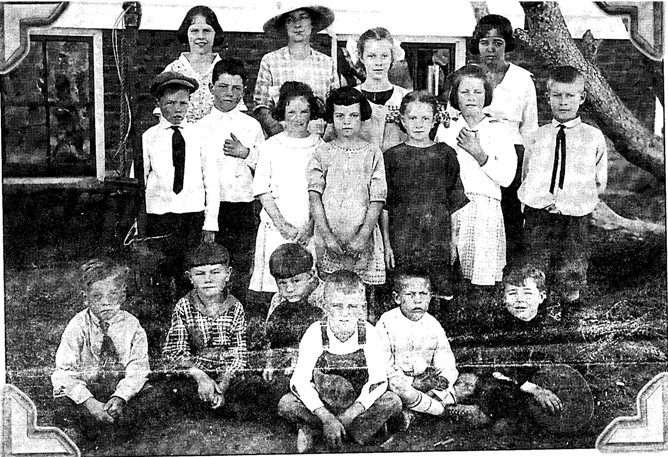 Mammoth Hot Springs School students are pictured in this 1921 photo with their teacher, Ellen Mariott (with hat). The three children who developed a plan to allow Santa Claus into Yellowstone Park on Christmas Eve are seated in the front row: Don Fraser, far left, Bud Trishman, fourth from left, and Spencer Dupre, far right. Photo courtesy of Don Fraser. 