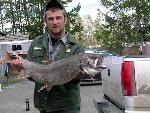An NPS employee holds a lake trout.