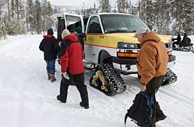 Visitors loading into a over-snow vehicle in Yellowstone Park.