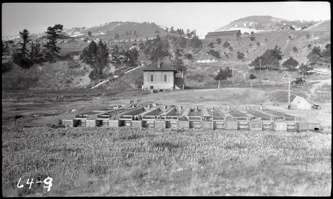 Many rows of wooden boxes used to raise trout