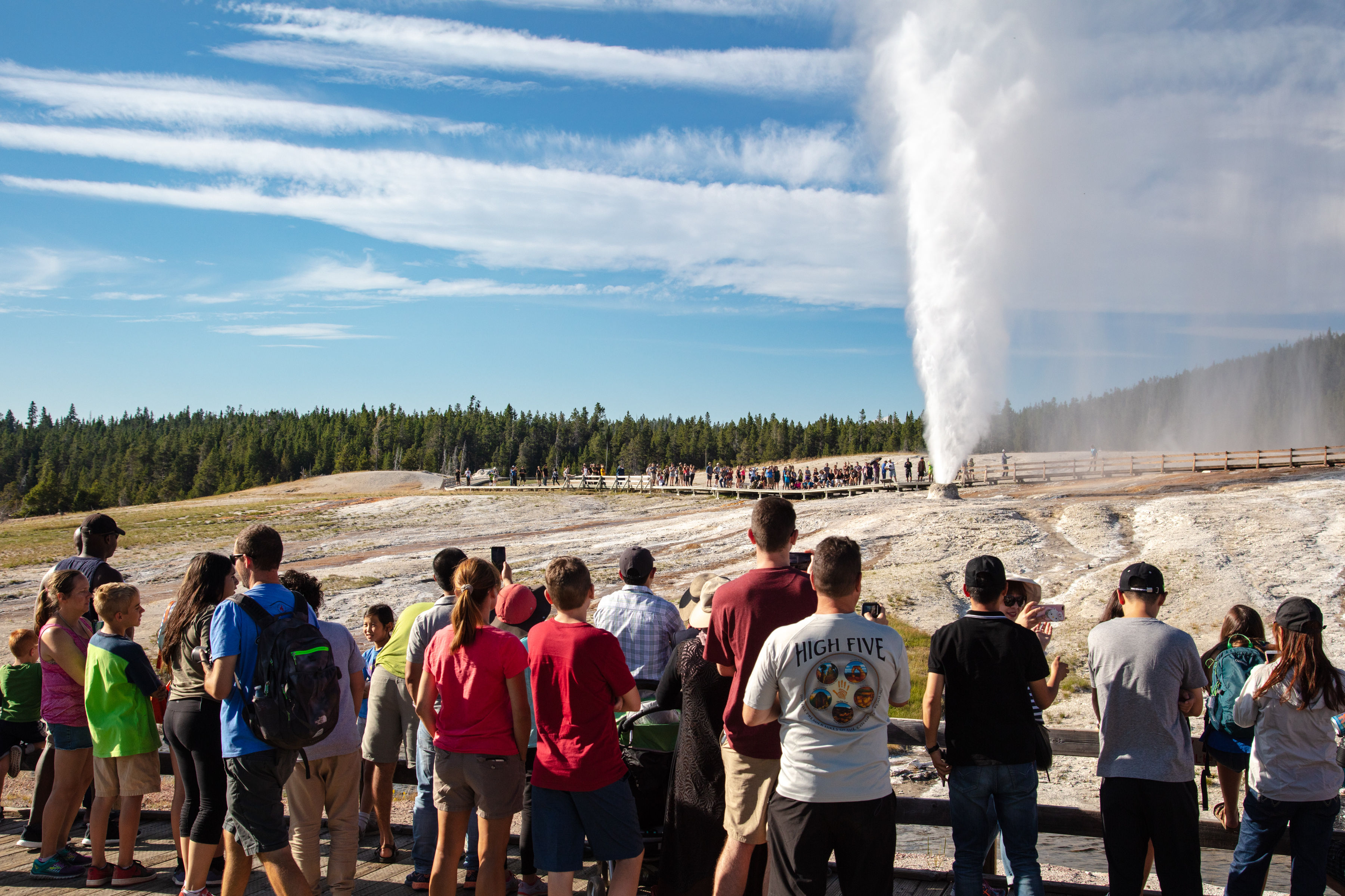 Visitors watching a geyser erupt