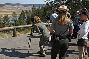 A ranger speaks with visitors viewing wildlife in Hayden Valley.