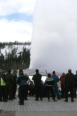 Winter visitors watch an eruption of Old Faithful Geyser