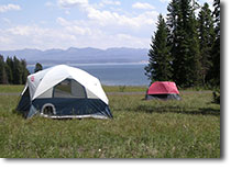 Campground with tents pitched with Yellowstone Lake in the background. Campground with tents pitched with Yellowstone Lake in the background.