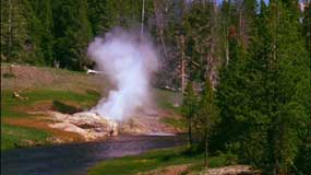 A screen capture from the new film Land to Life showing a riverside geyser erupting