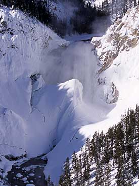 A dramatic image of the Lower Falls of the Yellowstone covered in snow and ice.
