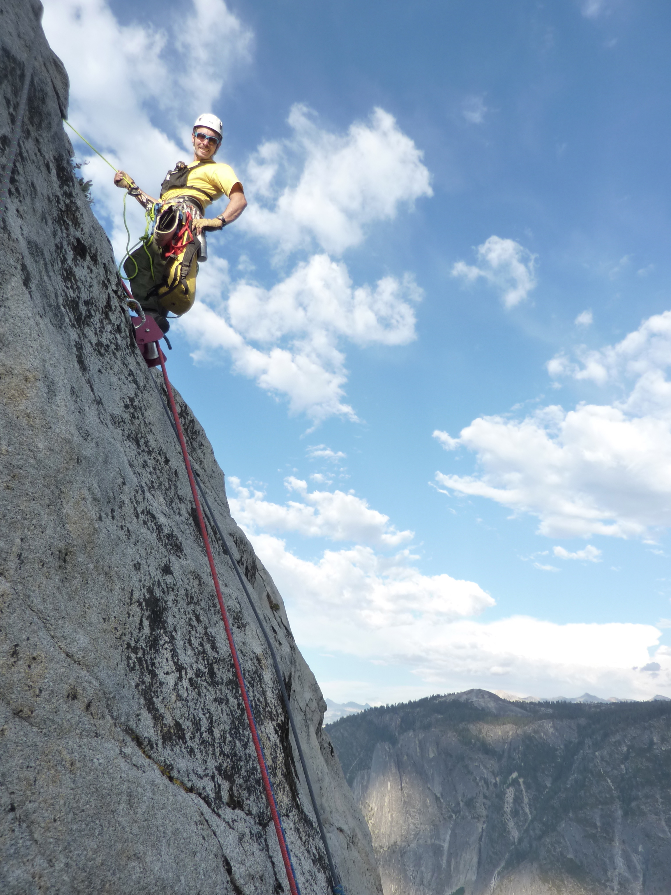 Search and Rescue employee rappelling down El Cap during a rescue.