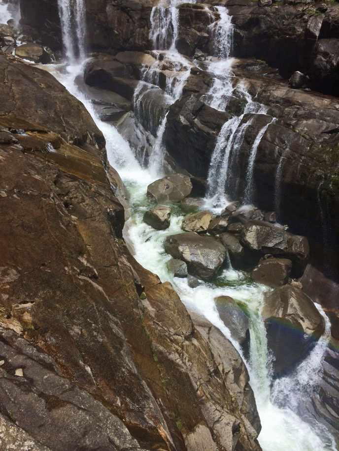 Cascades below Upper Yosemite Fall with hiker stranded on boulder